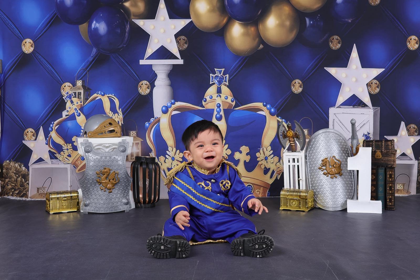 Archer laughing sitting on floor in prince suit